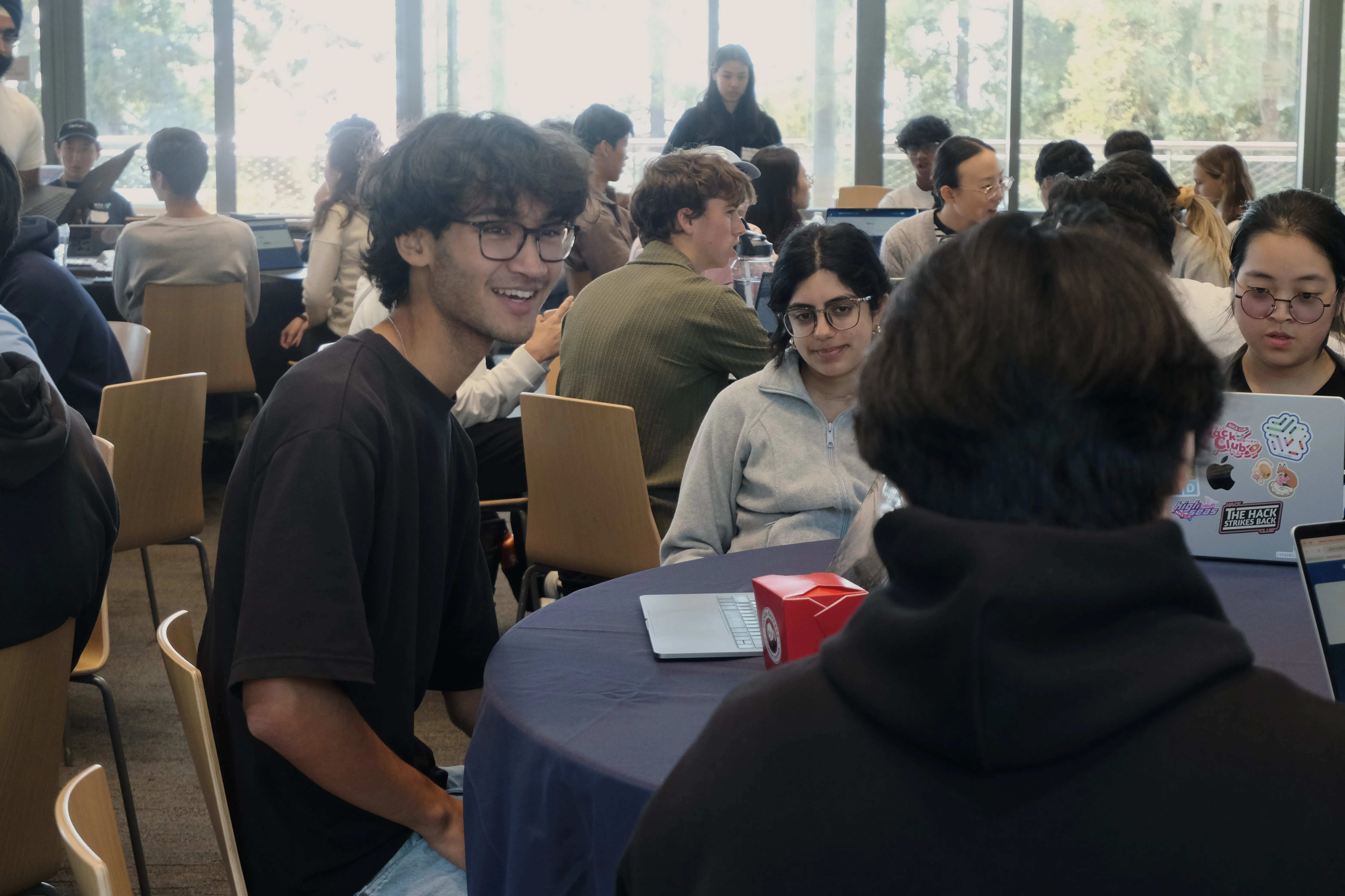 Students discussing a live trading game during the Invitational